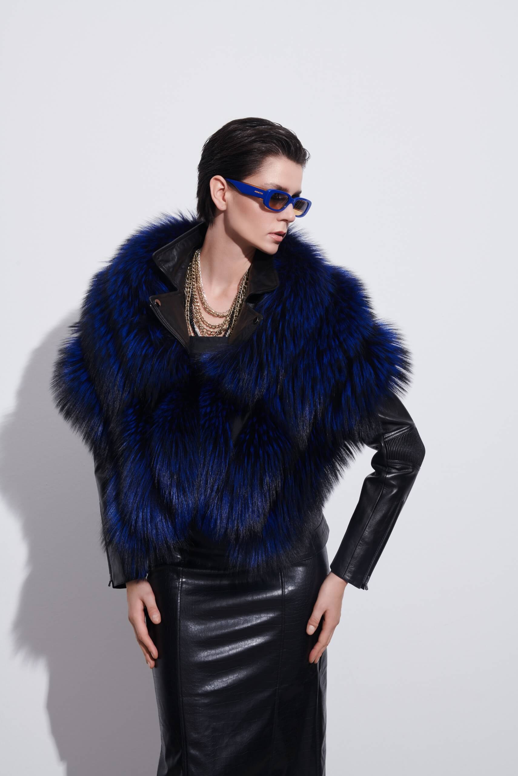 a woman in areal authentic fix fur poncho