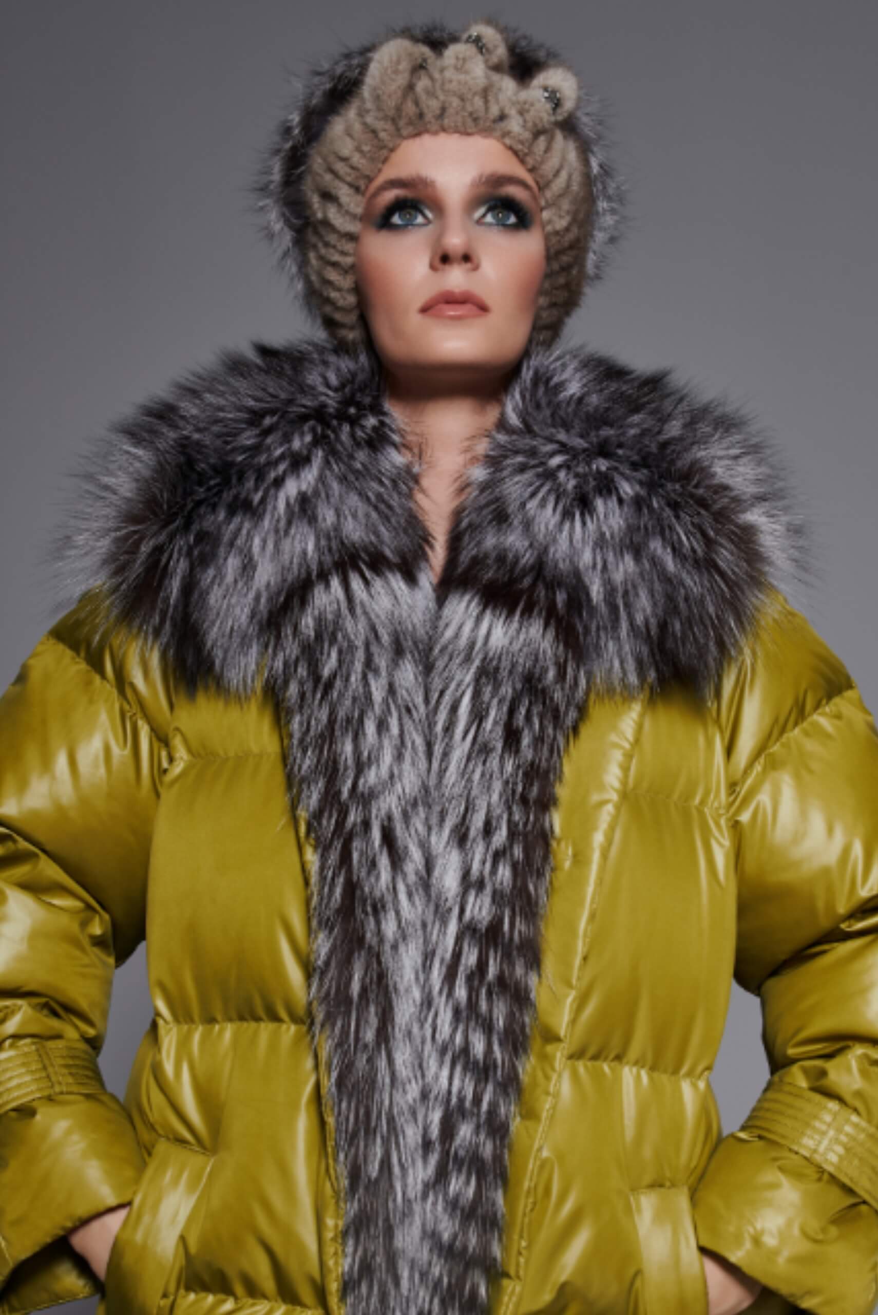 A woman wearing a fur coat with a fox fur collar and a fox fur head band
