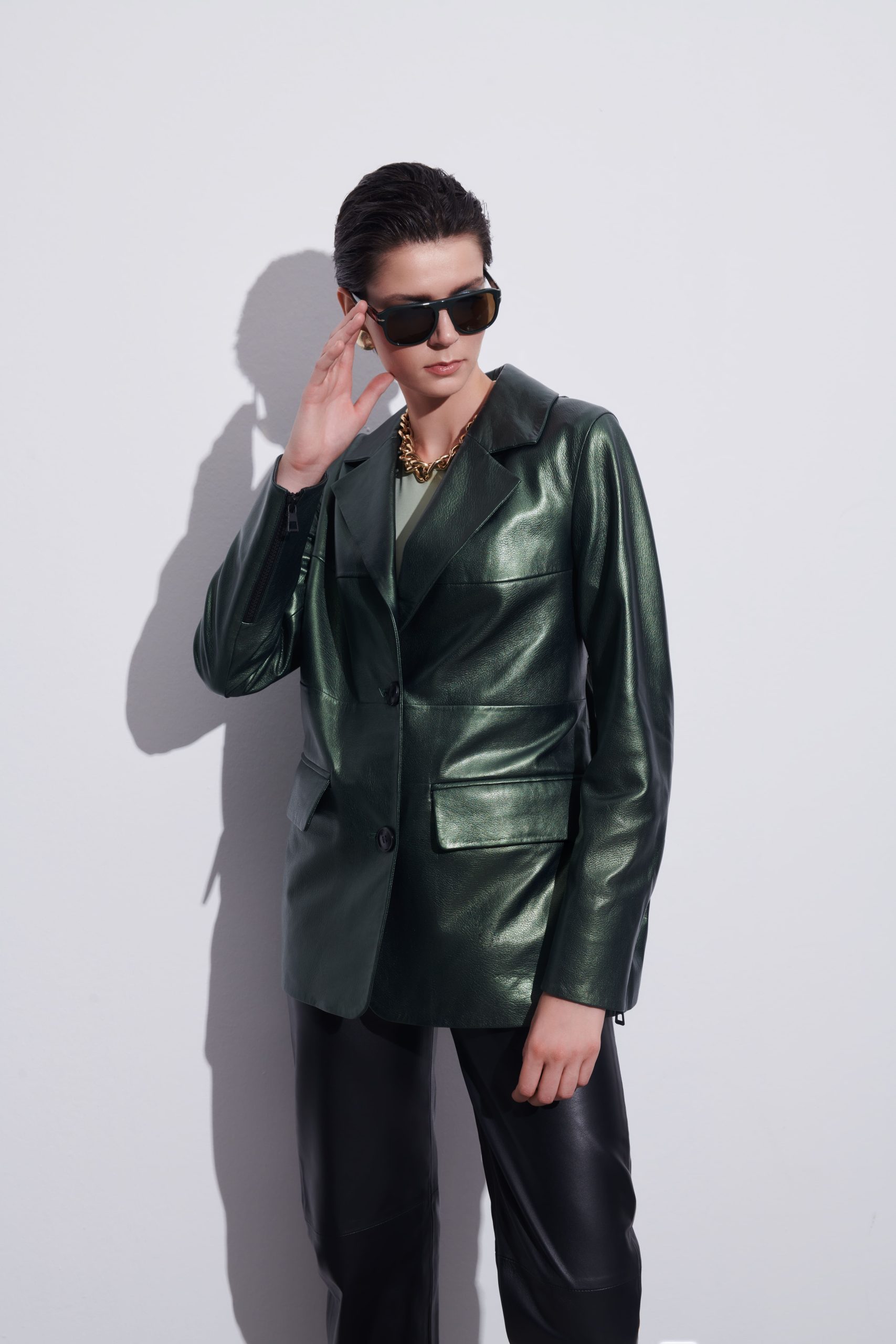 Woman in black leather jacket with black sunglasses